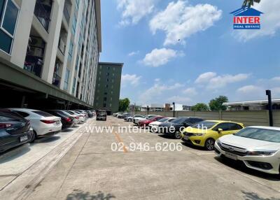 Exterior view of a modern residential building with a parking lot