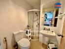 Compact bathroom with modern amenities and white tiling