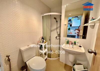 Compact bathroom with modern amenities and white tiling