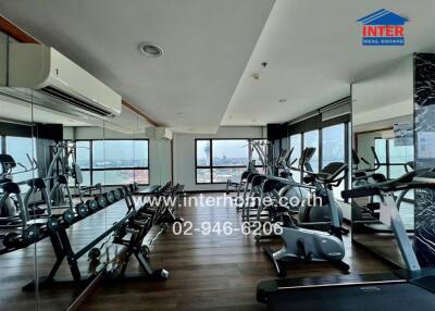 Spacious gym with modern equipment and city view