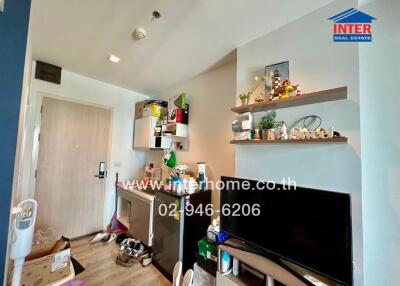 Modern living area with shelving units and multimedia setup