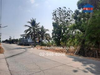 Suburban road with modern homes and lush greenery