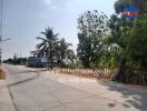 Suburban road with modern homes and lush greenery