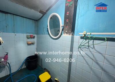 Compact bathroom with blue walls and essential amenities