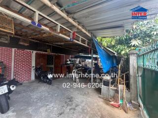 Cluttered residential garage space with motorcycles and visible storage