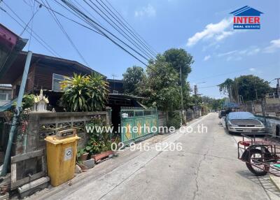 Urban street view with residential properties and parked vehicles