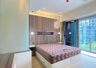 Modern bedroom with large window overlooking city