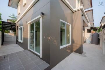 Exterior view of a modern two-story house with large windows and ceramic tile flooring