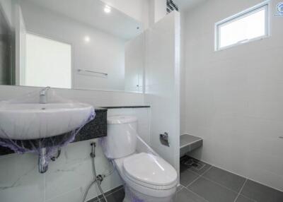 Modern bathroom with white walls and grey floor tiles