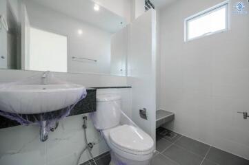 Modern bathroom with white walls and grey floor tiles