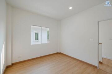 Bright and empty bedroom with wooden floor