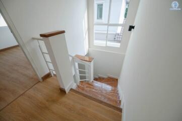 Bright and modern staircase with wooden flooring