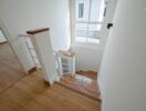 Bright and modern staircase with wooden flooring