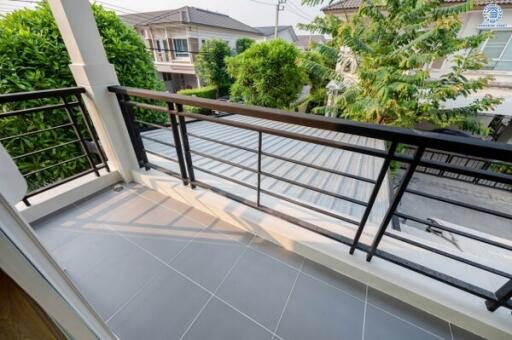 Spacious balcony with privacy fencing and greenery