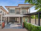 Modern two-story house with a carport and landscaped garden