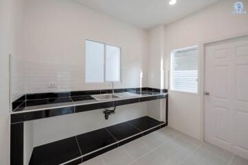 Modern kitchen with black countertops and white cabinetry