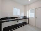 Modern kitchen with black countertops and white cabinetry