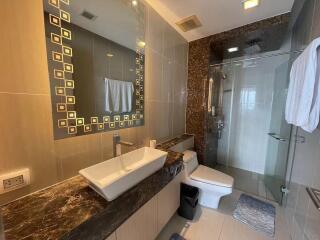 Modern bathroom with unique tiled walls and luxurious fixtures