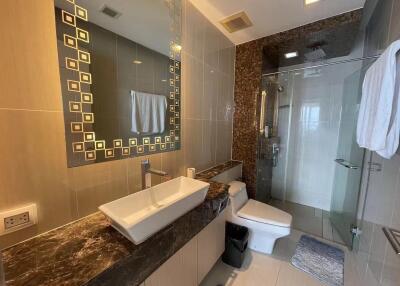 Modern bathroom with unique tiled walls and luxurious fixtures