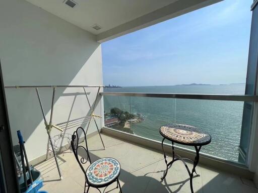 Scenic ocean view balcony with seating arrangement