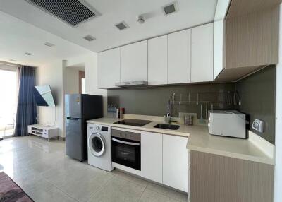 Modern kitchen with integrated appliances and adjacent living area