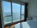Bright bedroom with panoramic sea view through large windows