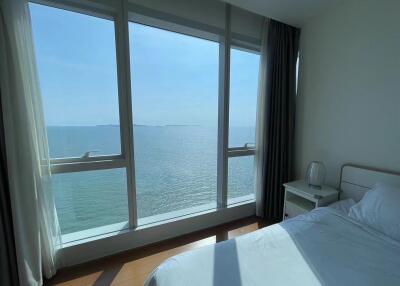 Bright bedroom with panoramic sea view through large windows