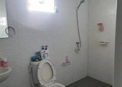 Modern white tiled bathroom with natural lighting