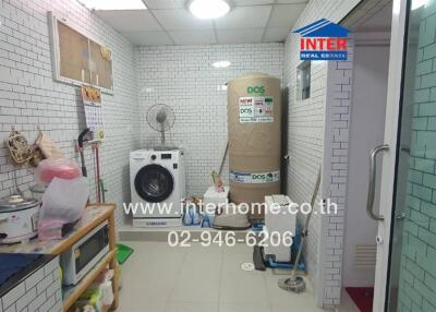 Utility room with washing machine and storage space