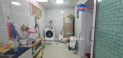 Utility room with washing machine and storage space