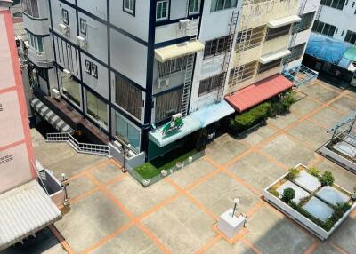 Aerial view of a modern multi-story building surrounded by other structures