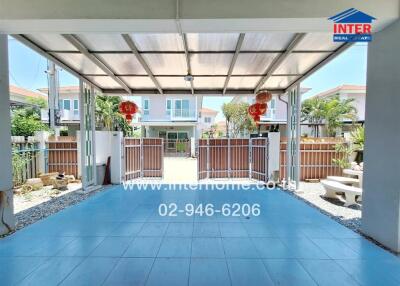 Spacious covered patio leading to a residential building