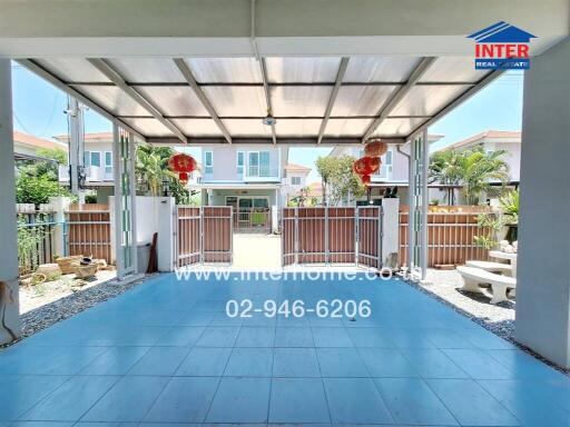 Spacious covered patio leading to a residential building