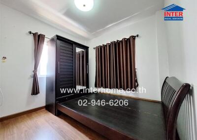 Spacious bedroom with large wardrobe and window