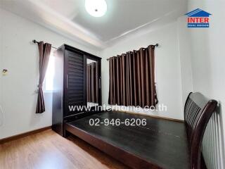 Spacious bedroom with large wardrobe and window