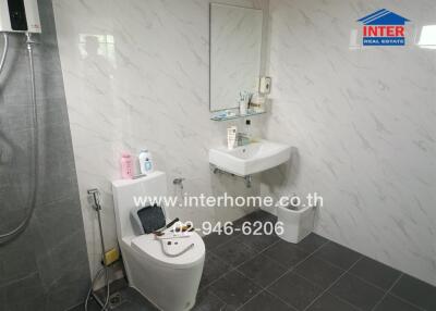 Modern bathroom with marble walls and tile flooring