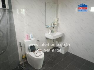 Modern bathroom with marble walls and tile flooring