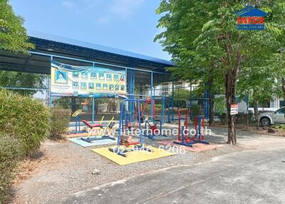 Colorful outdoor playground with fitness equipment and surrounding greenery