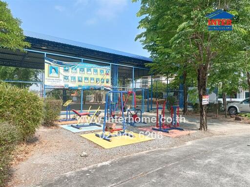 Colorful outdoor playground with fitness equipment and surrounding greenery