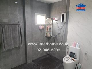 Modern bathroom with gray tiles and essential fixtures