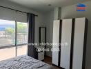 Spacious bedroom with large window and wardrobe