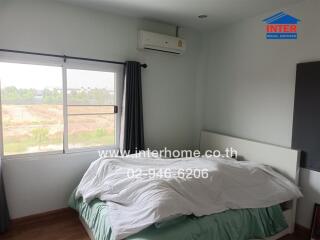 Cozy bedroom with large window and air conditioning unit
