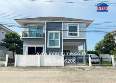 Modern two-story house with blue accents and a balcony