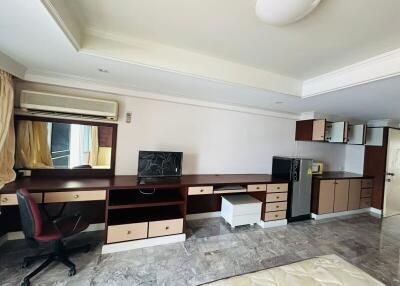Spacious bedroom with workstation and ample storage