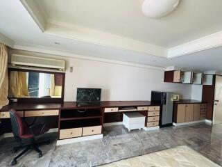 Spacious bedroom with workstation and ample storage