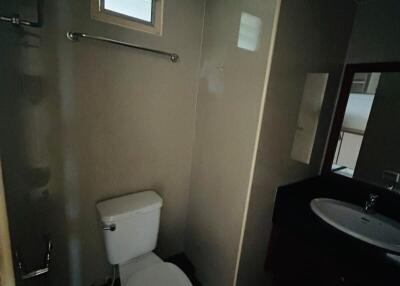 Compact dark-toned bathroom with basic fixtures
