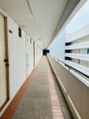 Long corridor in a residential building with multiple apartment doors