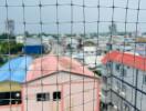 Blurry view through safety netting of urban houses