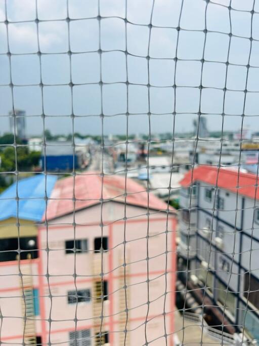 Blurry view through safety netting of urban houses