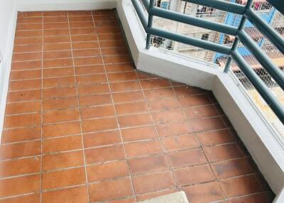 Small balcony with terracotta tiled flooring and railing